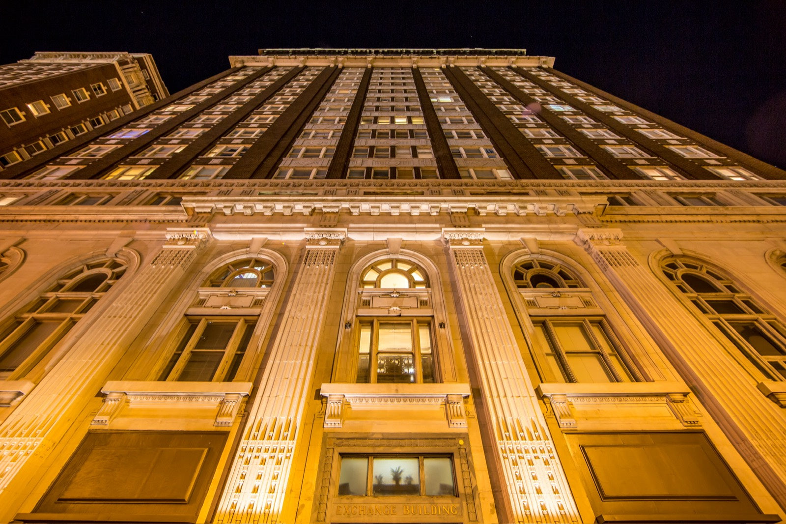 Illuminated Beaux-Arts facade of the Exchange Building at night