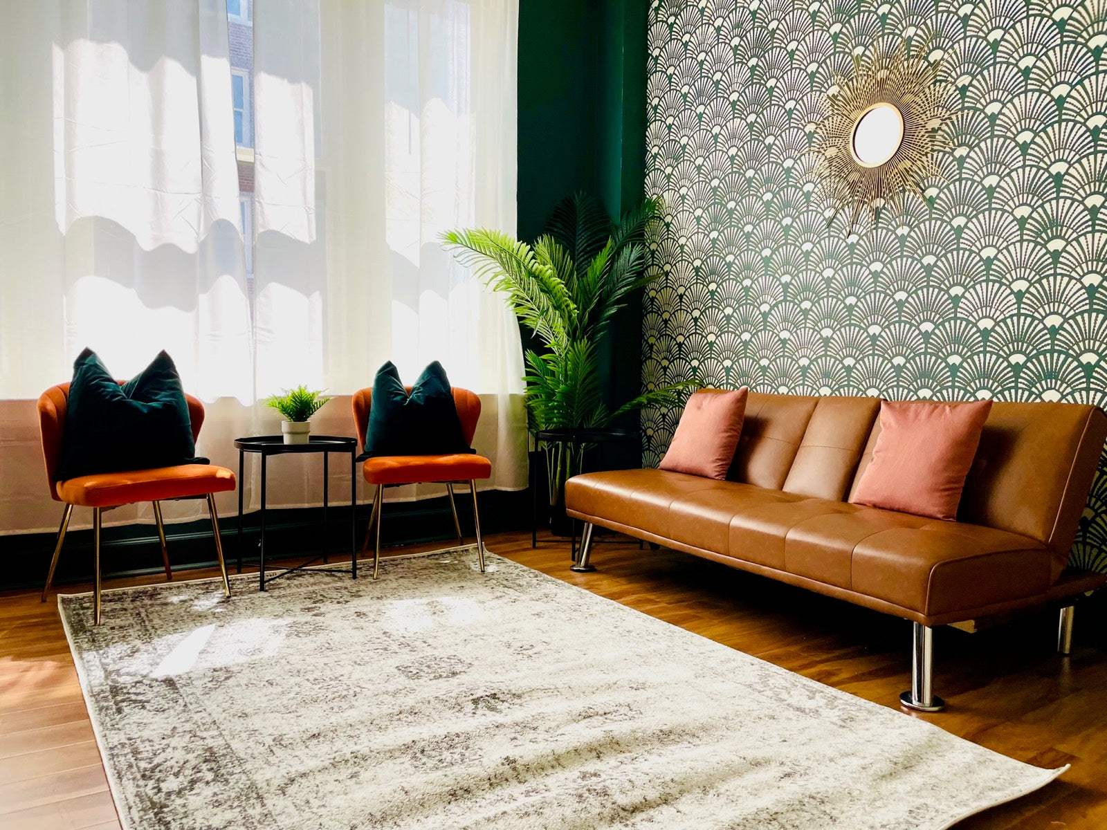 Furnished lounge with Art Deco wallpaper, leather sofa and sunburst mirror, Exchange Building Memphis