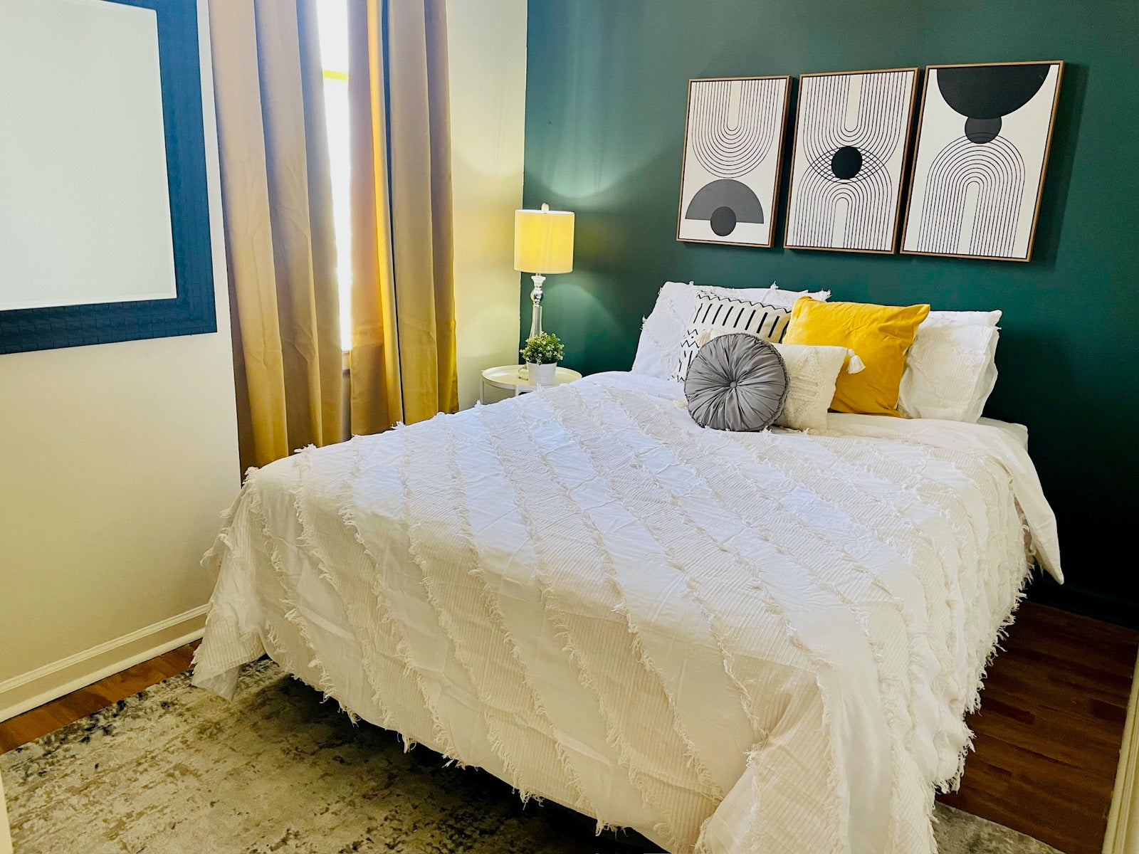 Furnished bedroom with emerald accent wall and modern art, Exchange Building Memphis