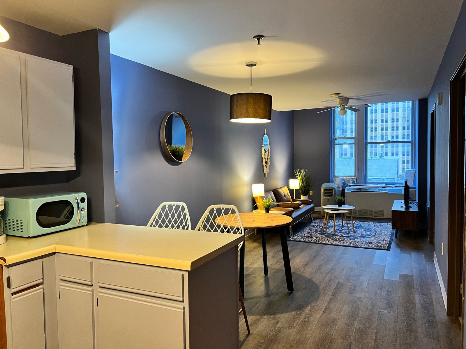 Furnished kitchen and living area with navy walls and skyline views, Exchange Building Memphis