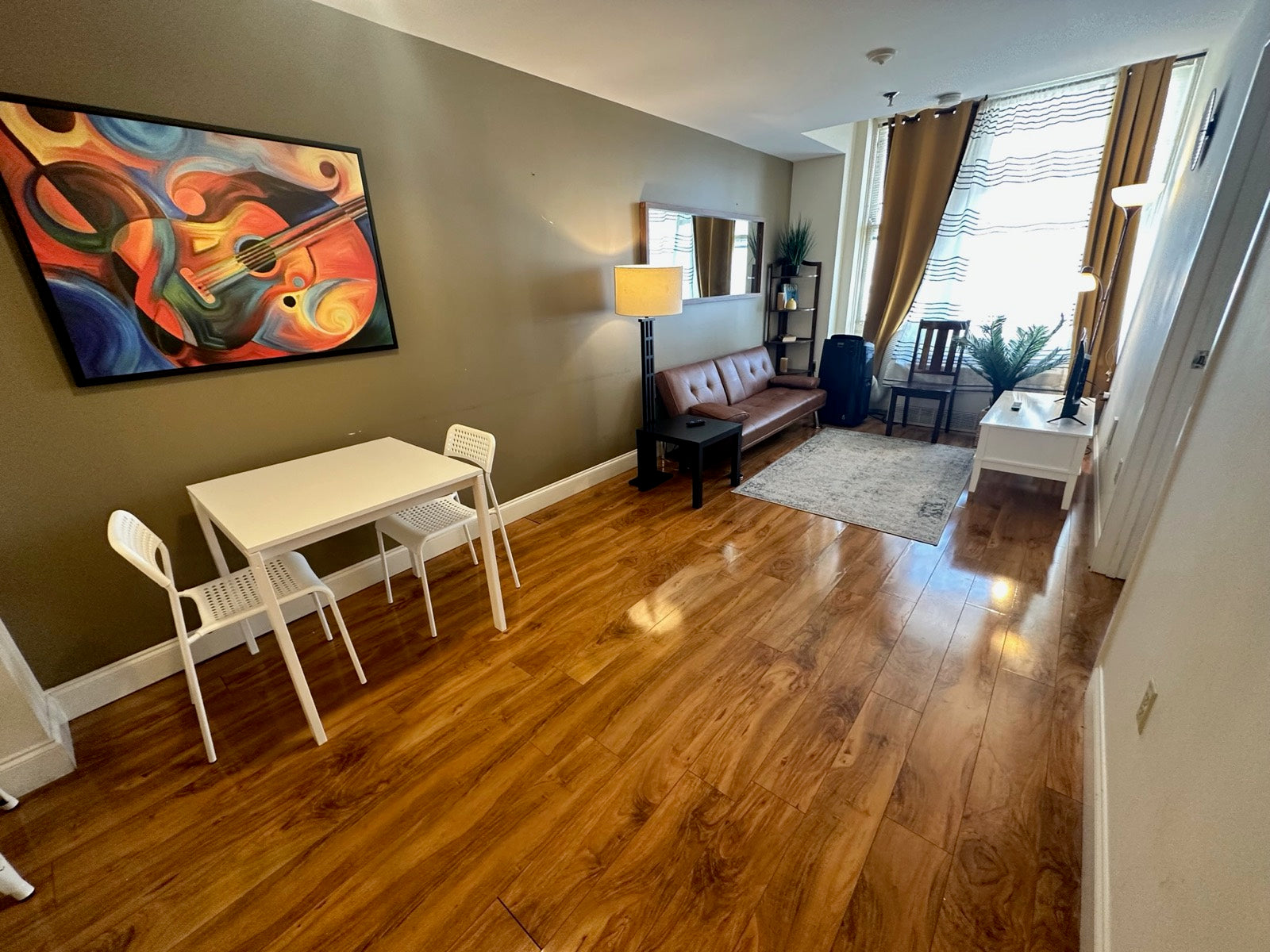 Furnished living and dining space with music-themed art, Exchange Building Memphis