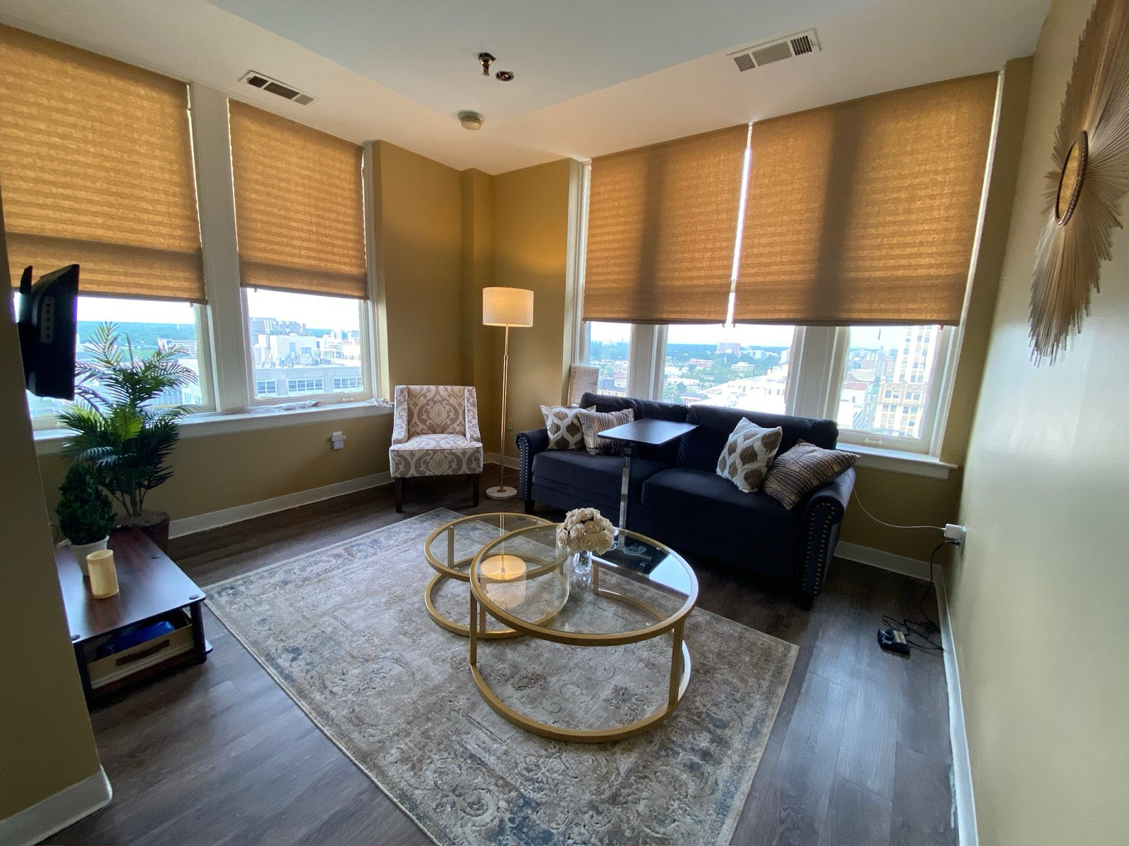 Furnished living room with navy tufted sofa and skyline views, Exchange Building Memphis